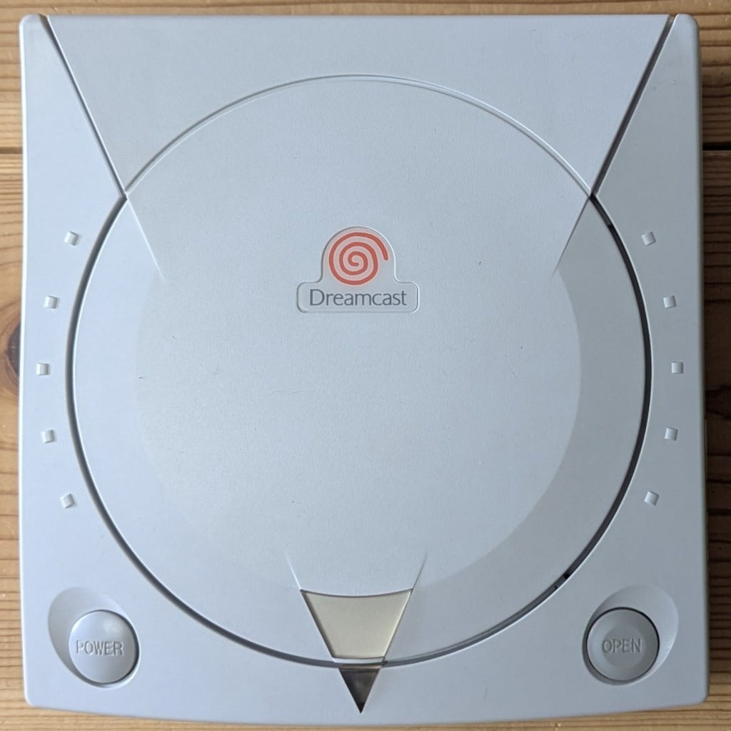 Sega Dreamcast HKT-3000 console top lid power button open button and orange swirl logo