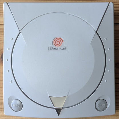 Sega Dreamcast HKT-3000 console top lid power button open button and orange swirl logo