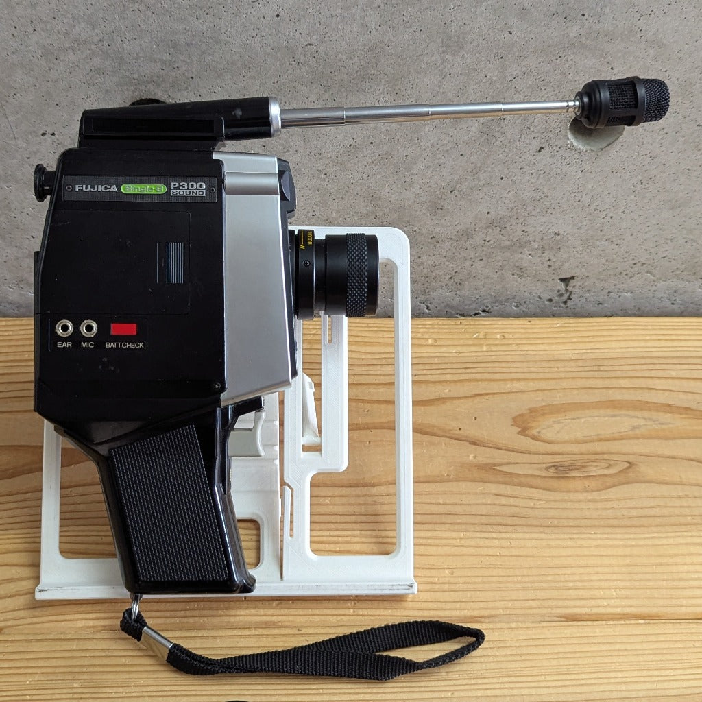 Fujica Single-8 Sound P300 side view with telescopic microphone fully extended and wrist strap