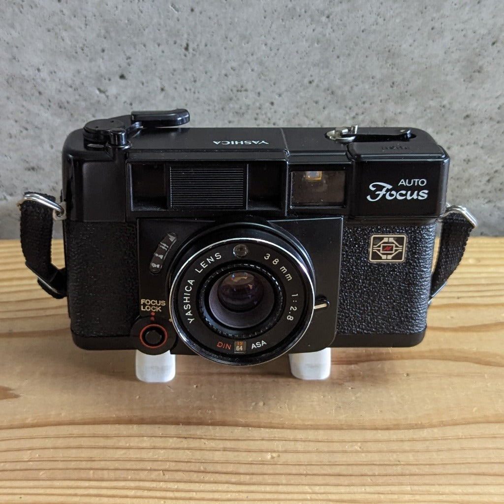 Yashica Auto Focus front view showing Yashica Lens 38mm 1 2.8 and focus lock button