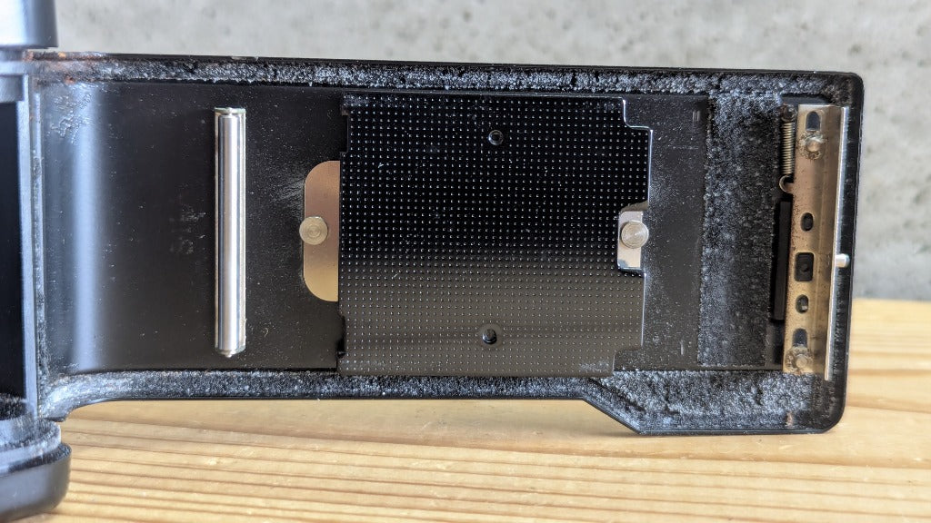 Yashica Auto Focus macro of rear door interior showing film pressure plate and light seal foam