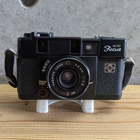 Yashica Auto Focus 35mm vintage camera isometric view with strap and Yashica 38mm f2.8 lens