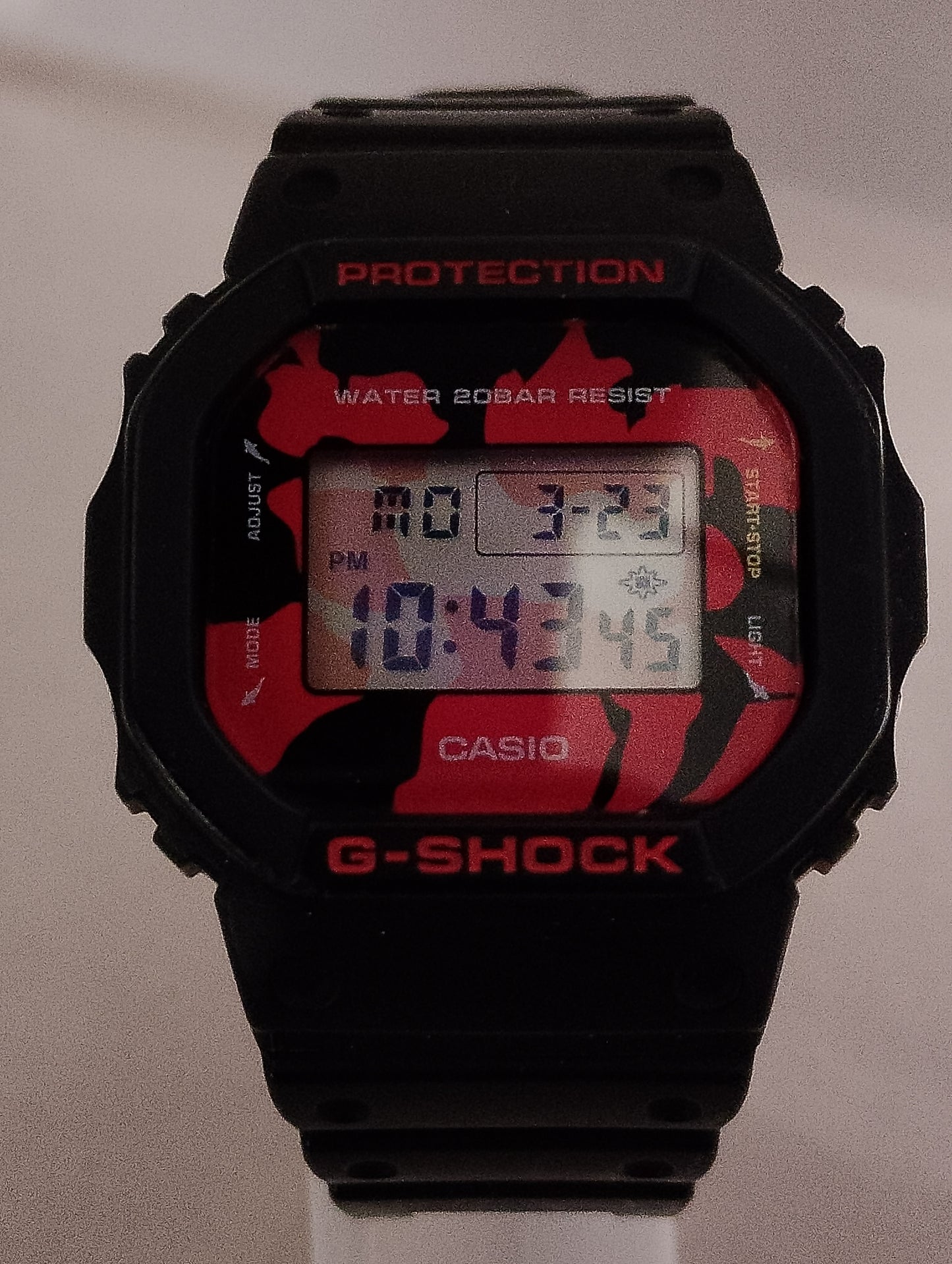 asio G-Shock DW-5600JK-1 Nishikigoi edition with red and black pattern front view.