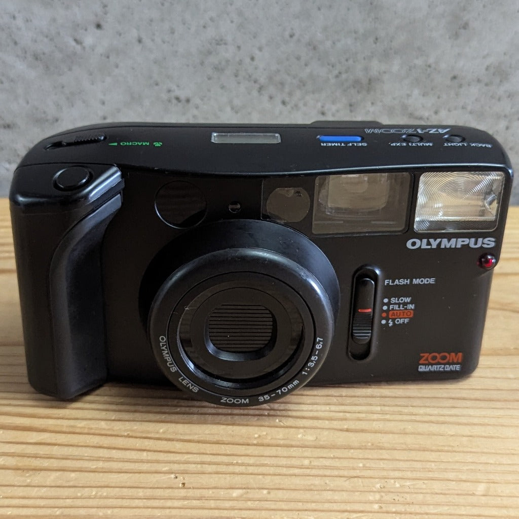 Olympus AZ-1 Zoom QuartzDate front view showing 35-70mm lens flash mode selector and Olympus branding