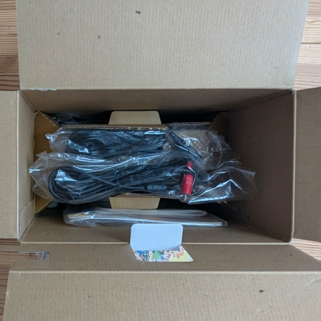 Sega Dreamcast White Box opened showing inner cardboard inserts bagged cables and manuals