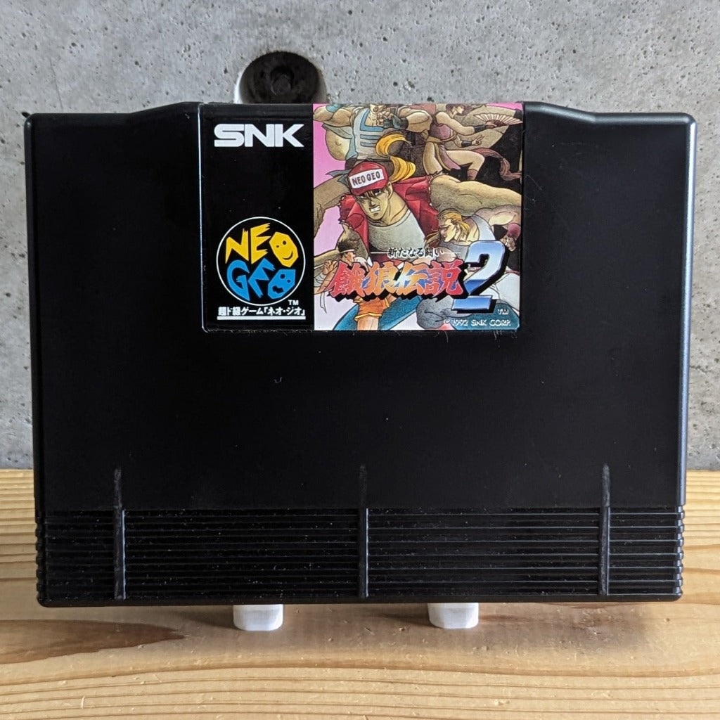 Garou Densetsu 2 Fatal Fury 2 Neo Geo AES official ROM cartridge front view on stand with original glossy label