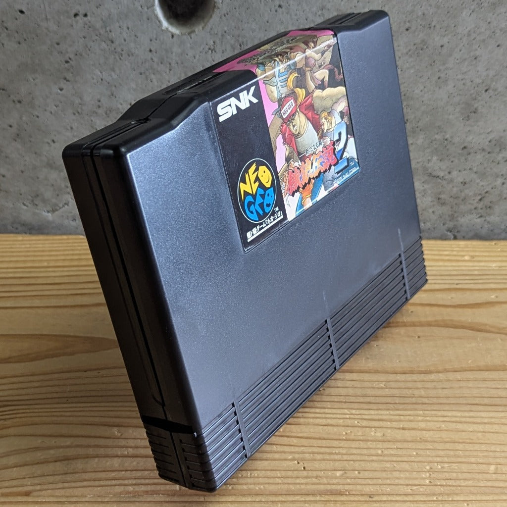 Perspective view of Garou Densetsu 2 Fatal Fury 2 Neo Geo AES cartridge on stand showing authentic SNK casing