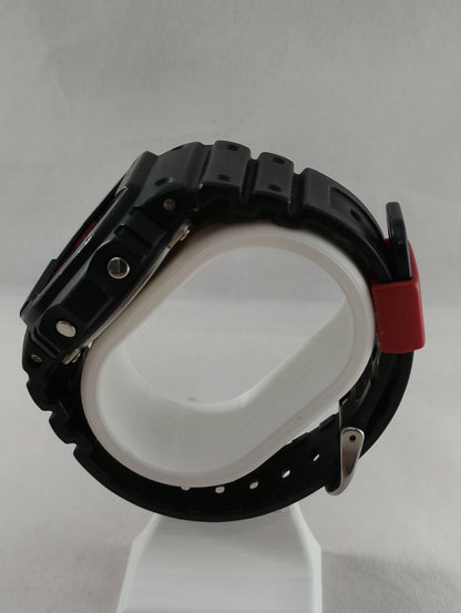 Side profile of G-Shock DW-5600JK-1 showing adjustment buttons and case thickness