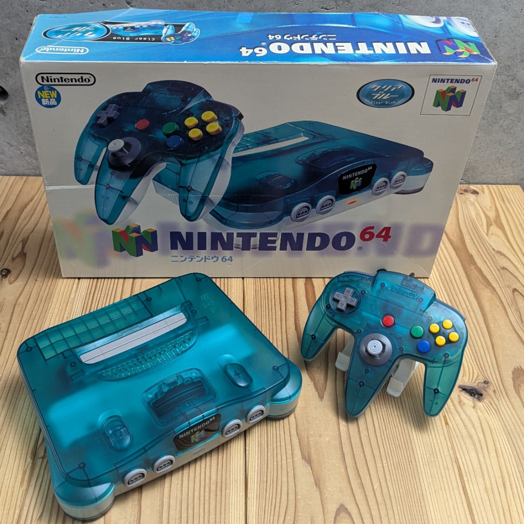 Nintendo 64 Clear Blue console and matching controller in front of original Japanese retail box CIB
