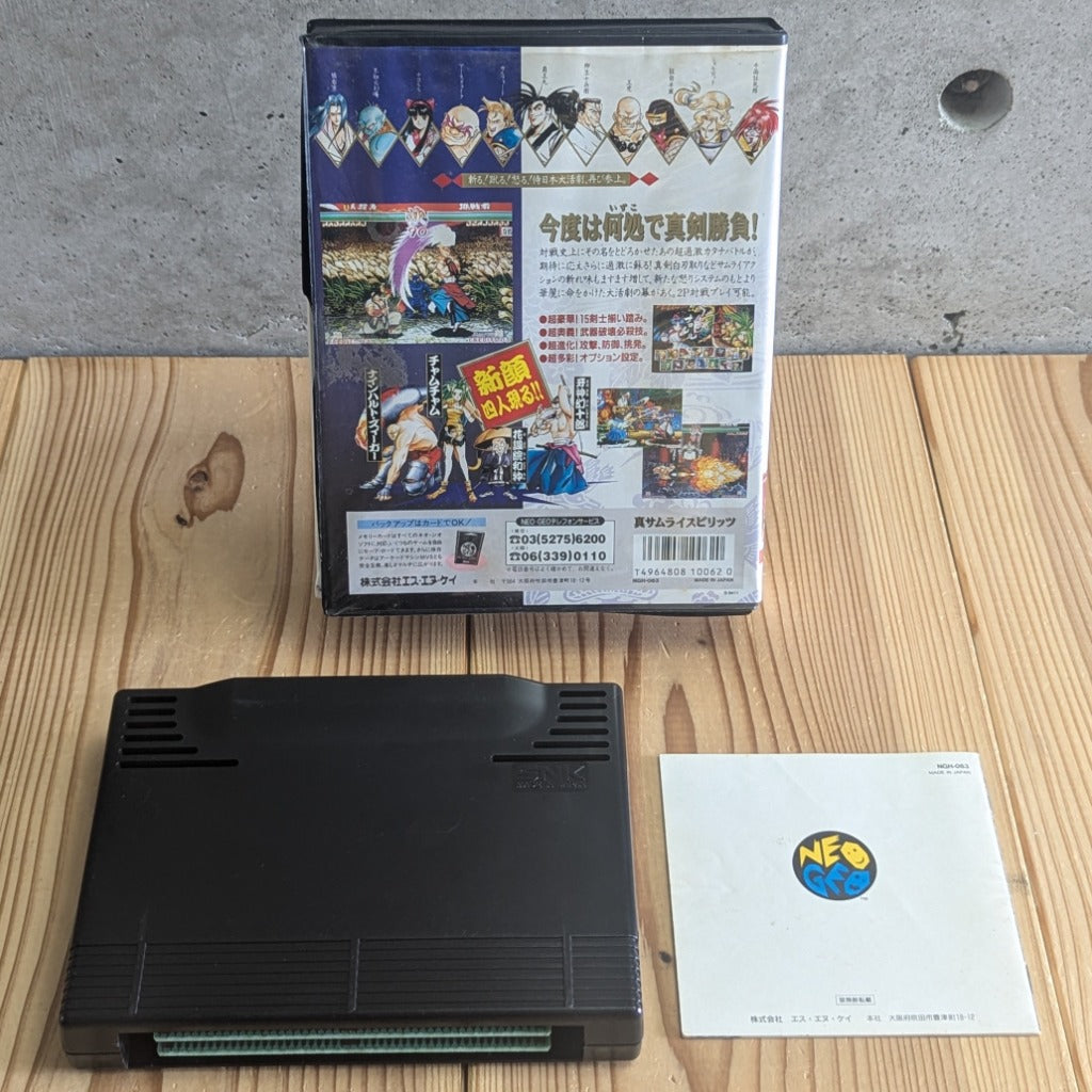Rear view of complete Shin Samurai Spirits Neo Geo AES set showing back of clamshell case cartridge back and instruction manual