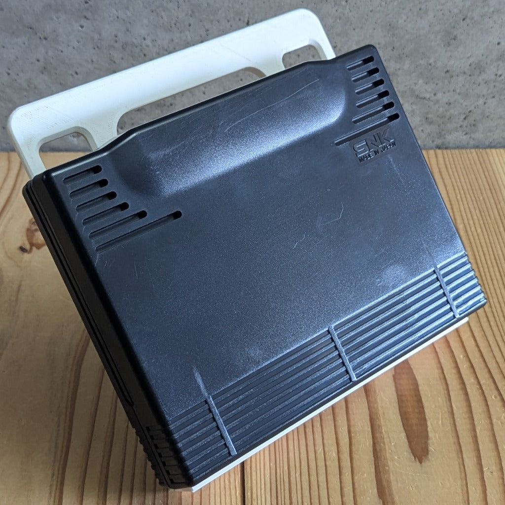 Rear side of official SNK Neo Geo AES ROM cartridge showing authentic molded casing and Made in Japan logo