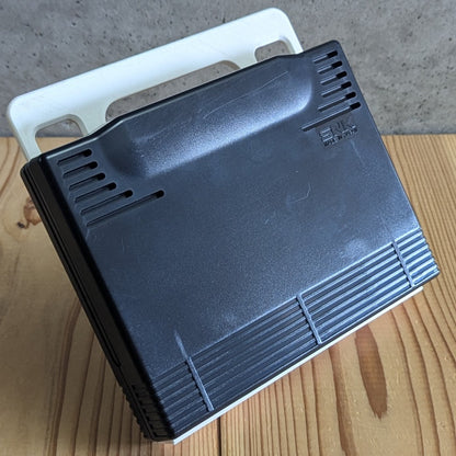 Rear side of official SNK Neo Geo AES ROM cartridge showing authentic molded casing and Made in Japan logo