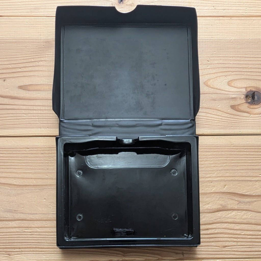 Inside view of opened SNK Neo Geo AES soft clamshell case showing original internal cartridge holding tray