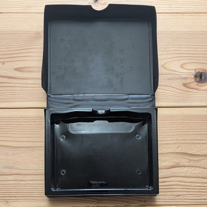 Inside view of opened SNK Neo Geo AES soft clamshell case showing original internal cartridge holding tray